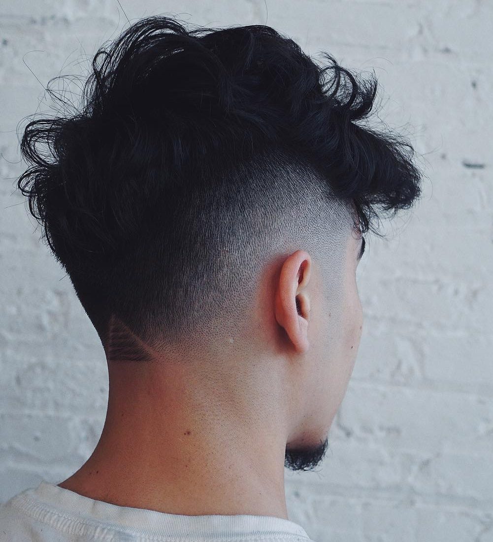 Messy hairstyle for men with thick hair and burst fade