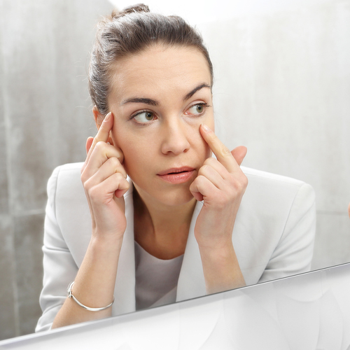 Woman checking her eye bags