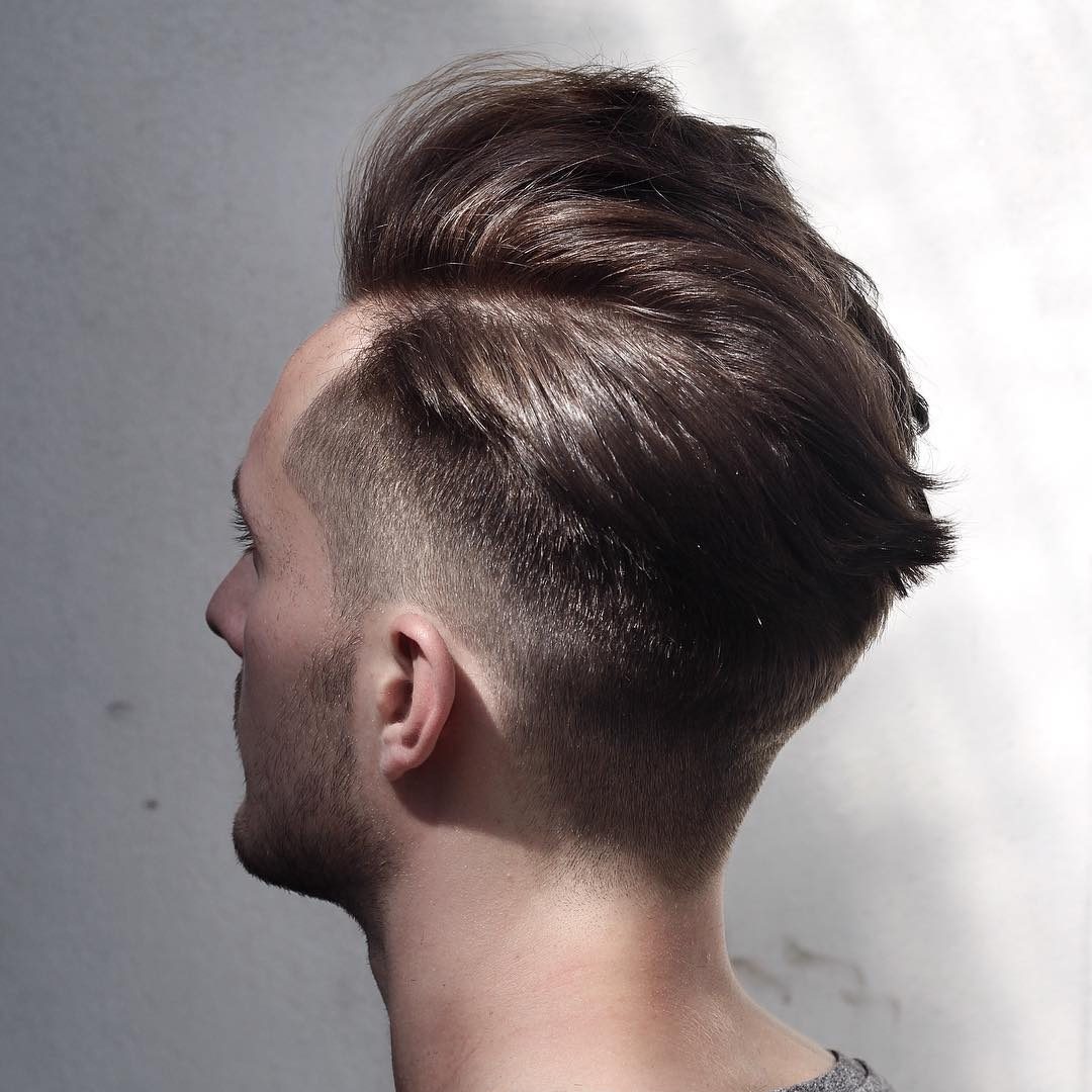 Stylish mens haircut with natural movement and mid fade