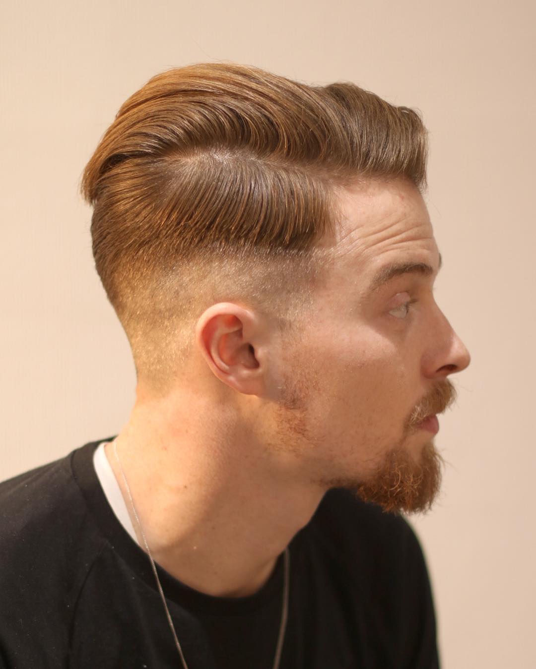 Side part hairstyle for men with a low fade