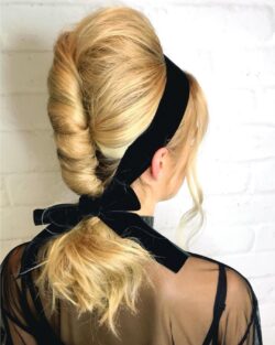 A black velvet bow tied in Christmas party hair by Rush.