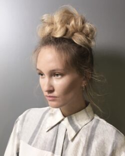 Blonde topknots creating volume emphasising style.