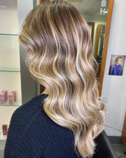 Loose waves on blonde tresses, styled by Rush.