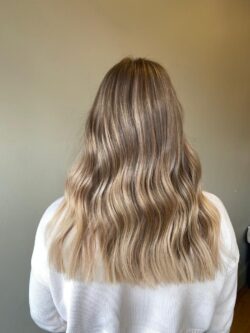 Wavy hair with colour corrected blonde highlights.