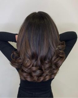 A Christmas party bouncy blow dry hairstyle by Rush.